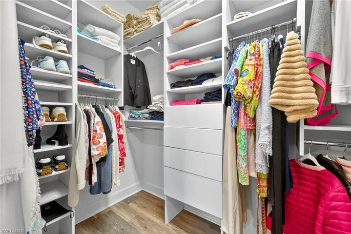 Walk in closet featuring light wood-style flooring