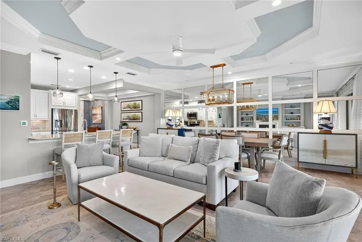 Living room featuring crown molding, coffered ceiling, ceiling fan, and recessed lighting