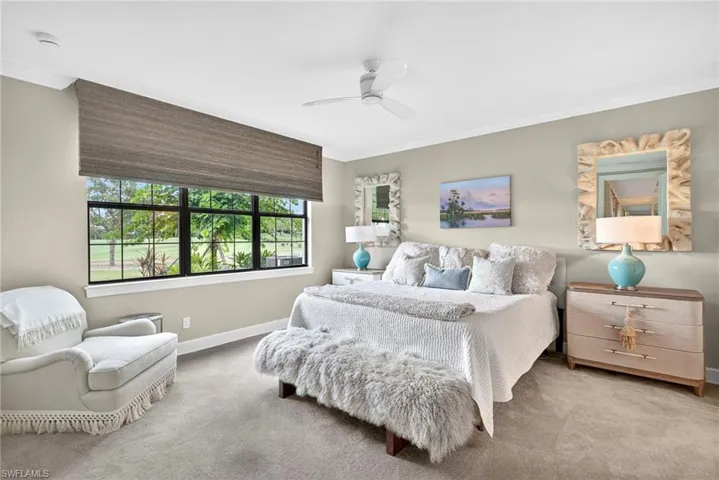 Bedroom featuring crown molding, carpet floors, and a ceiling fan
