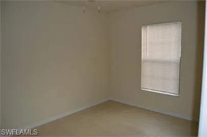 Spare room featuring baseboards