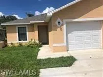 Single story home featuring concrete driveway, a front lawn, stucco siding, and a garage