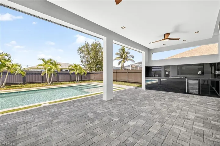 View of pool featuring ceiling fan, a fenced backyard, a patio, and area for grilling