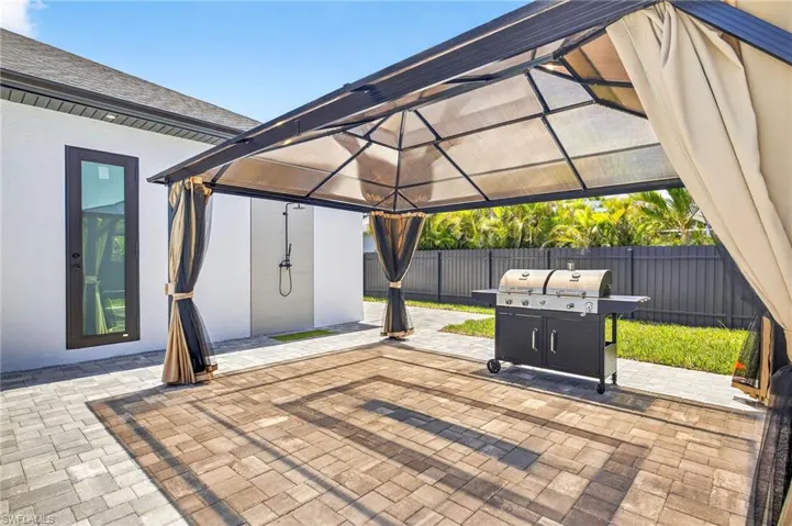View of patio with a gazebo and area for grilling