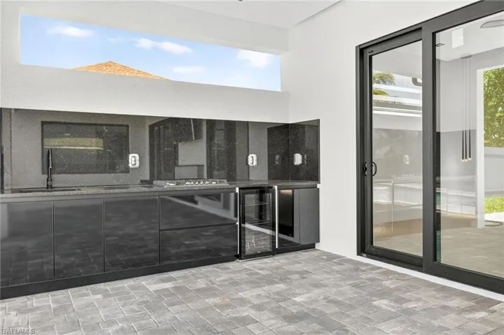 View of patio / terrace with beverage cooler and a sink