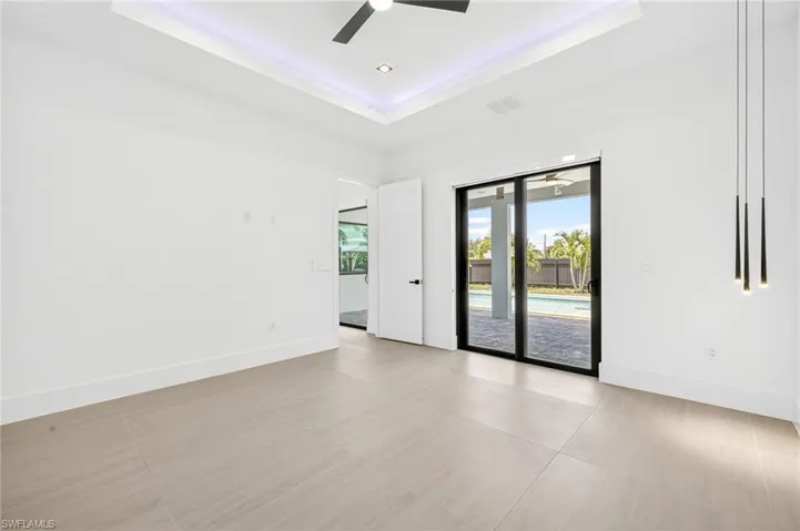 Spare room with ceiling fan and a raised ceiling