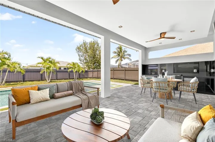 Fenced backyard with an outdoor hangout area, a ceiling fan, outdoor dining space, and a patio