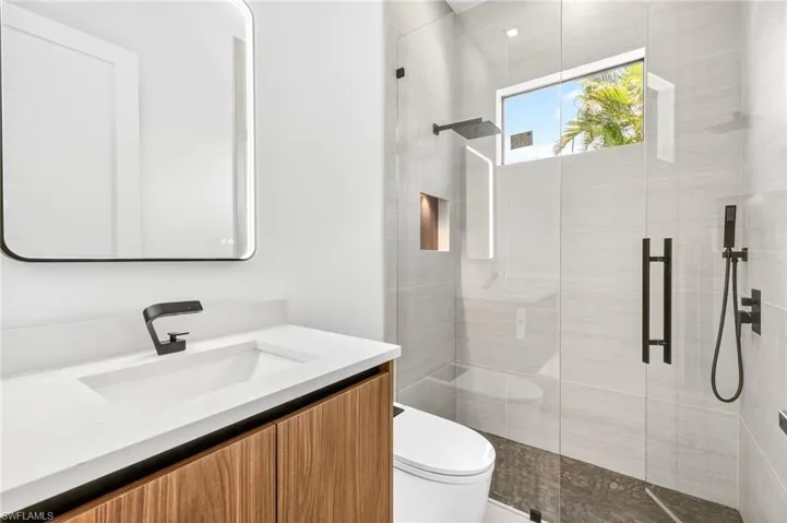 Bathroom featuring a stall shower and vanity