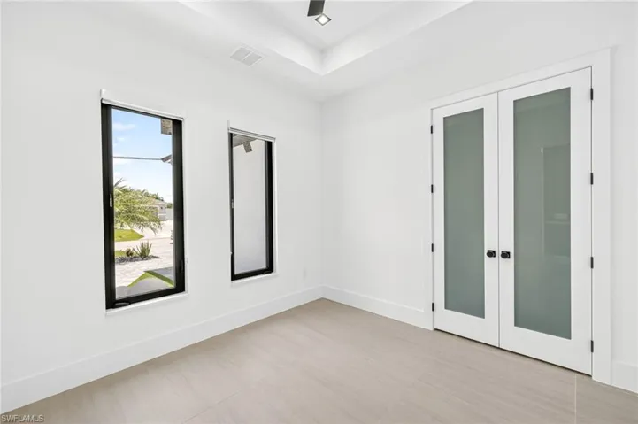 Unfurnished room with french doors and baseboards