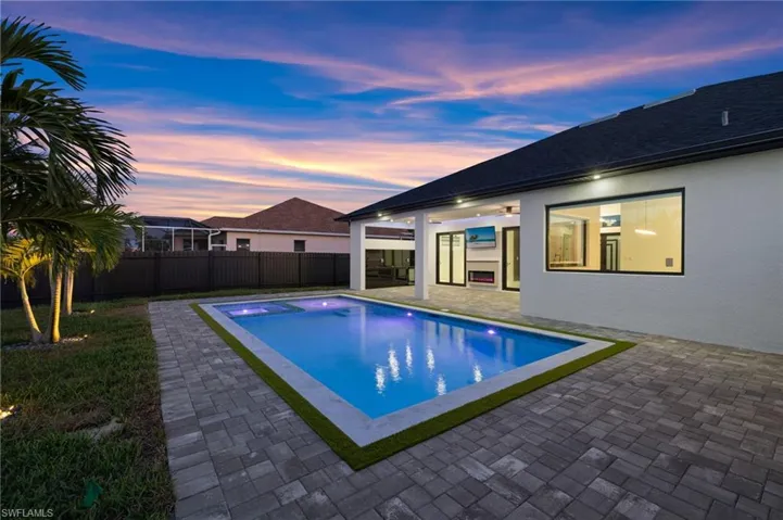 View of swimming pool with a patio, a fenced backyard, and a pool with connected hot tub