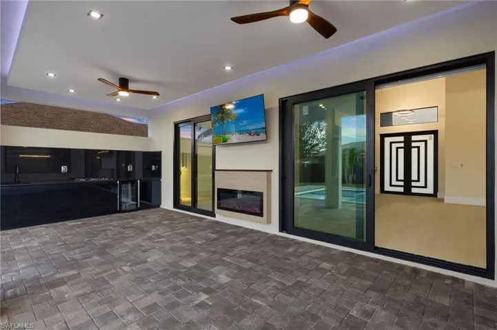 View of patio with a ceiling fan and a sink