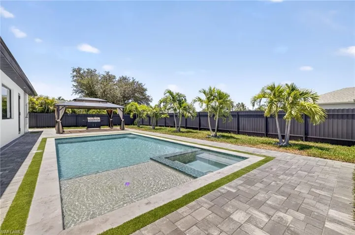 View of pool featuring a gazebo, a pool with connected hot tub, a fenced backyard, and a patio area