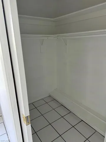 Spacious closet featuring tile flooring