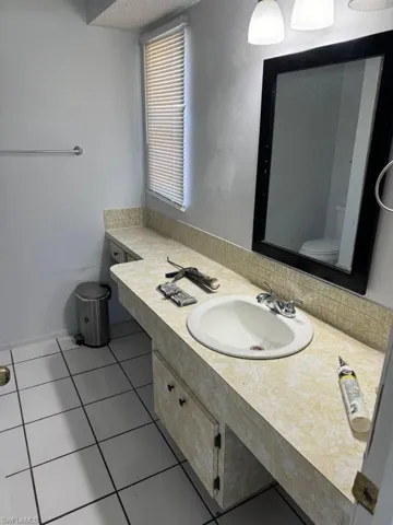 Bathroom with tile flooring, toilet, and vanity