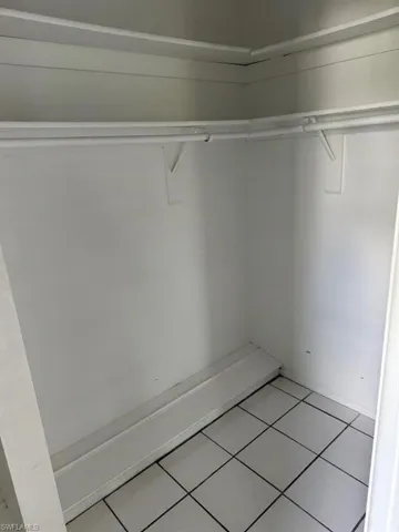 Walk in closet featuring tile floors