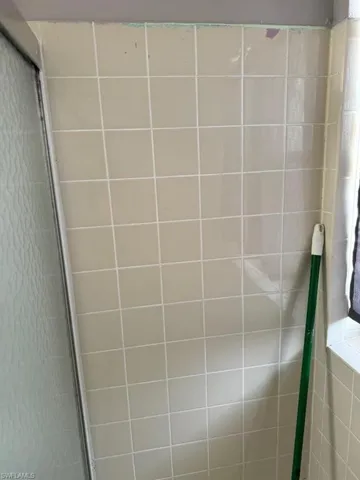 Interior details featuring a shower with shower door