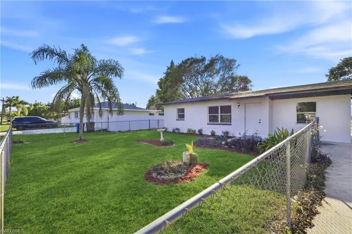View of front of property with a fenced backyard and stucco siding
