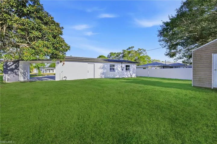 Back of property with an outbuilding