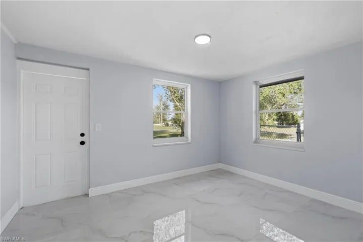 Spare room featuring light marble finish flooring