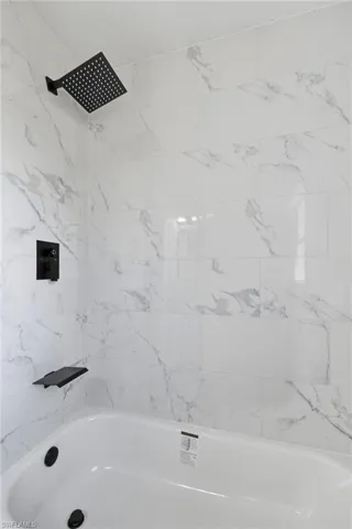 Full bath featuring shower / tub combination
