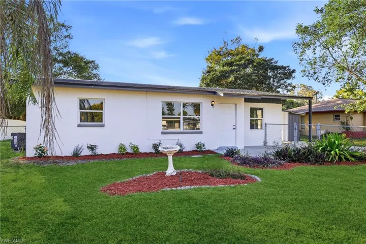 Ranch-style house featuring stucco siding