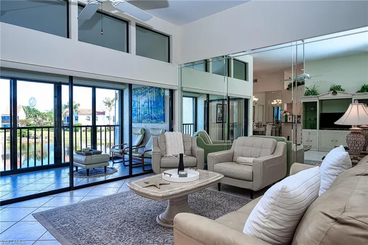 Living room lanai, hight ceilings  and lake view water feature.