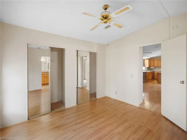 Unfurnished bedroom with light wood-type flooring and ceiling fan