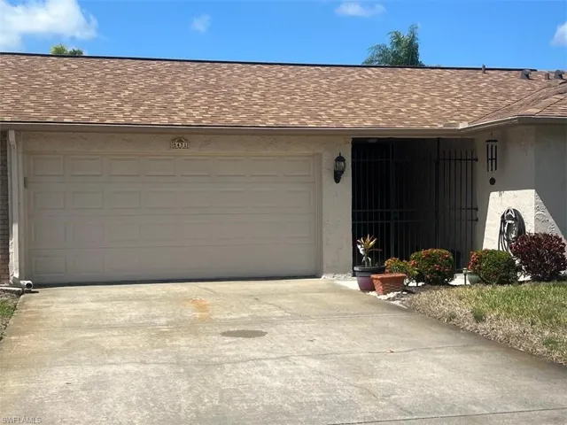 Garage featuring concrete driveway