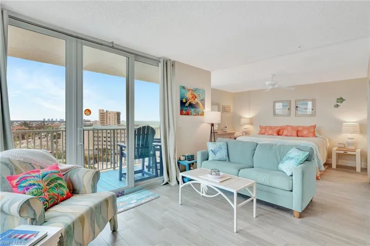 Balcony featuring view of water and beach