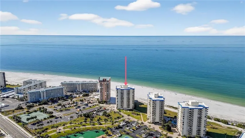 Drone / aerial view of expansive coastline and apartment complex / building