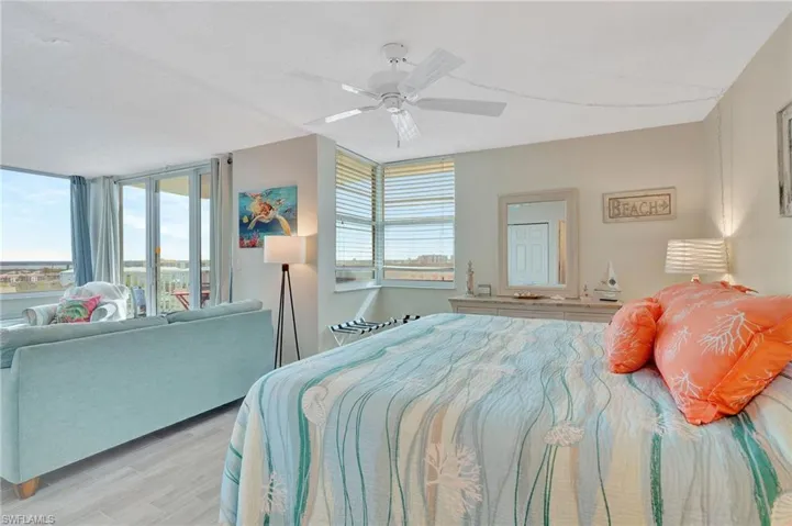 Bedroom with wood finished floors, a ceiling fan, and access to outside
