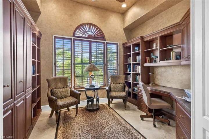 Office area with built in desk and recessed lighting