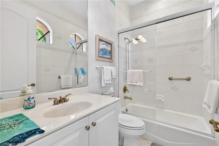 Full bathroom with vanity and shower / bath combination with glass door