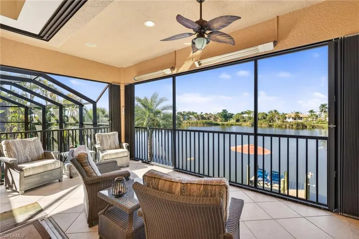 Sunroom / solarium featuring a water view