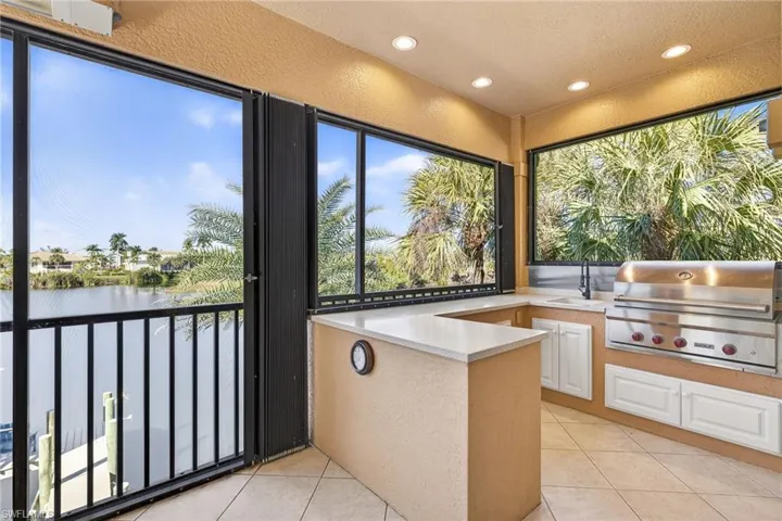 Outdoor Kitchen featuring a water view and a sink