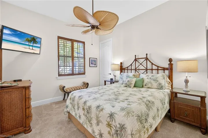 Bedroom with light colored carpet and ceiling fan