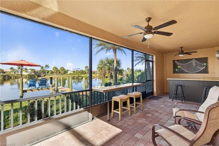 Patio with a water view and a textured ceiling