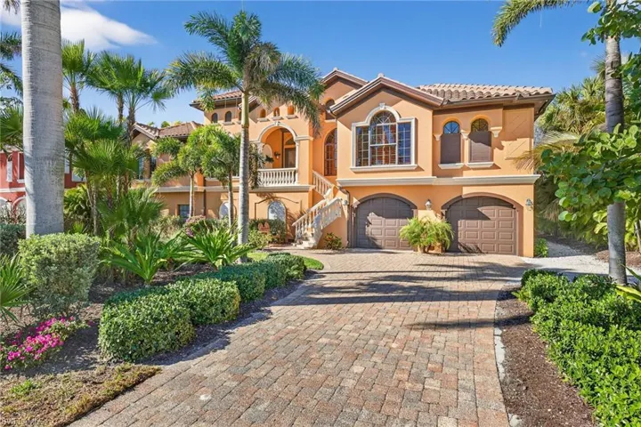 Mediterranean / spanish-style home featuring decorative driveway, stucco siding, a tiled roof, an attached garage, and a balcony
