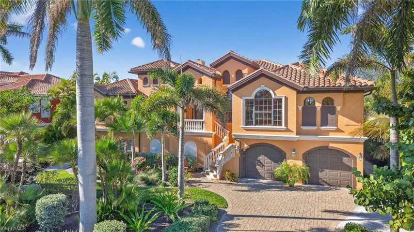 Mediterranean / spanish-style house featuring a tile roof, stucco siding, stairs, and decorative driveway