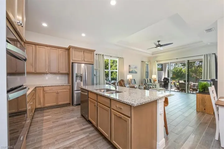 Kitchen looking out to great room with a beautiful ceiling fan in the great room