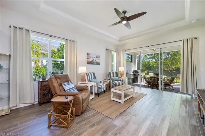 Entering the great room with beautiful wide wood-like tile flooring throughout the home