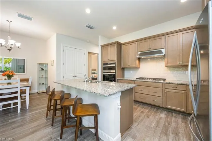 Gourmet kitchen facing dining area and pantry