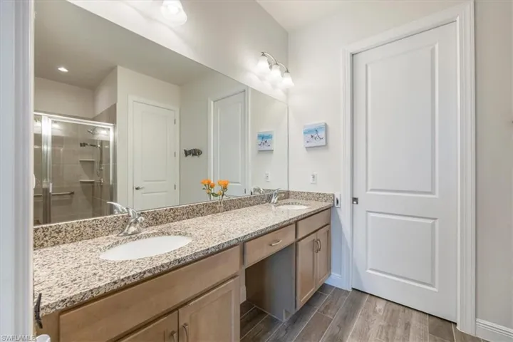 Owner's suite bathroom with granite dual sink vanity counter-top