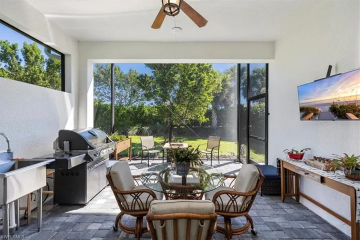 Extended patio with screened cage. Outdoor sink with gas hookup for BBQ grilling