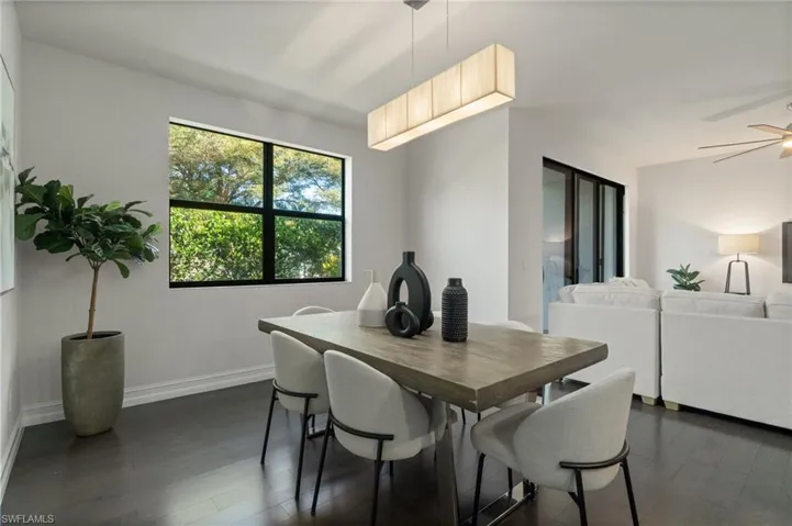 Dining area featuring dark wood finished floors and ceiling fan