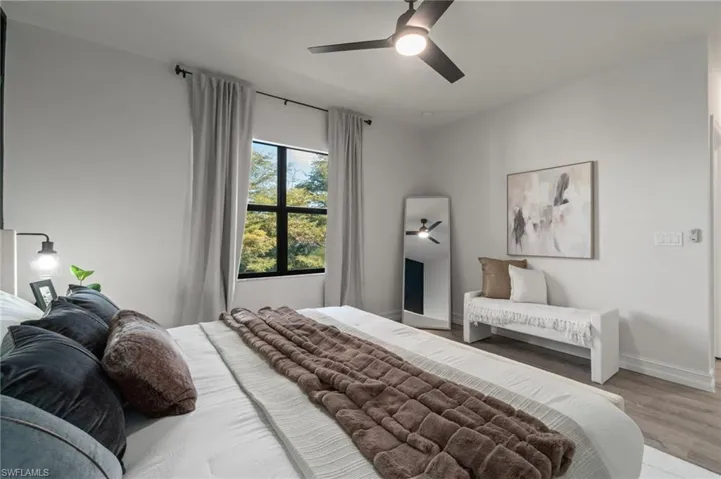 Bedroom with a ceiling fan and wood finished floors