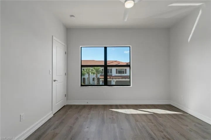 Spare room with wood finished floors and baseboards
