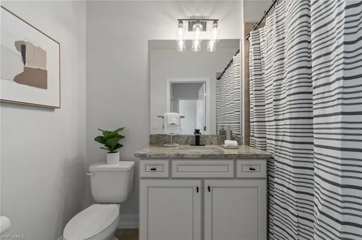 Full bathroom featuring vanity and a shower with curtain