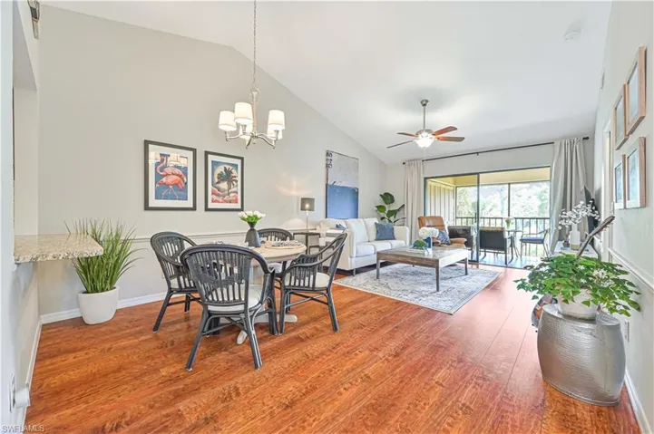Open concept dining/living space with high cathedral ceilings.