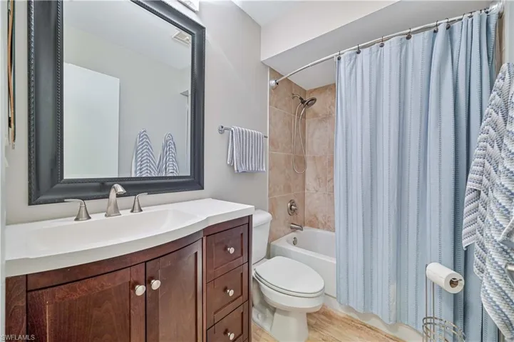 Guest bathroom with new vanity, countertop, faucet, mirror, and freshly painted walls.