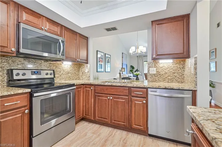 Tray ceiling and wide- open view to the outside landscaping.